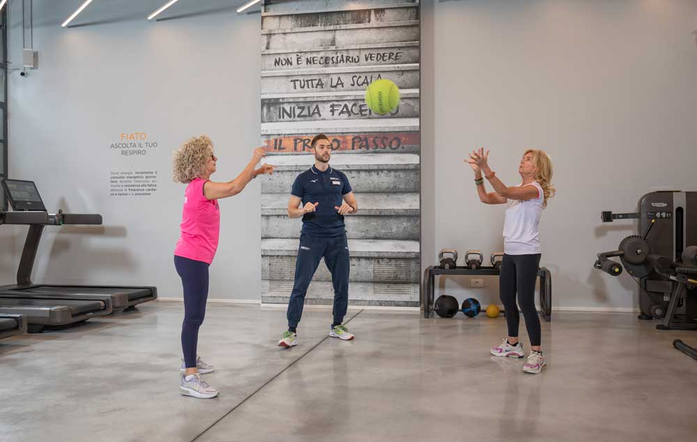Dos mujeres entrenando y disfrutando de su tiempo con un entrenador personal